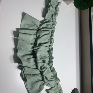 A very light green color shirt crop top